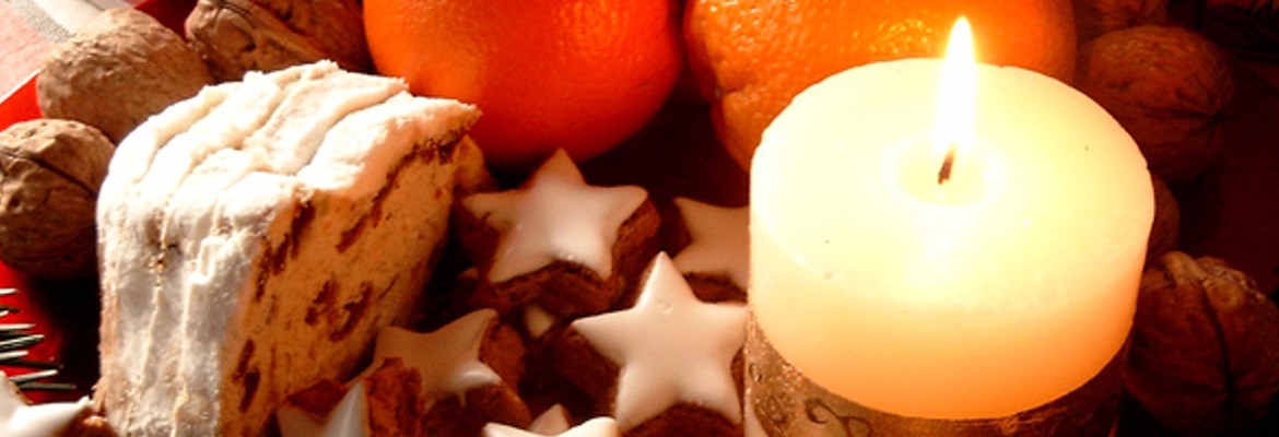 Candle, cakes, cookies and an orange